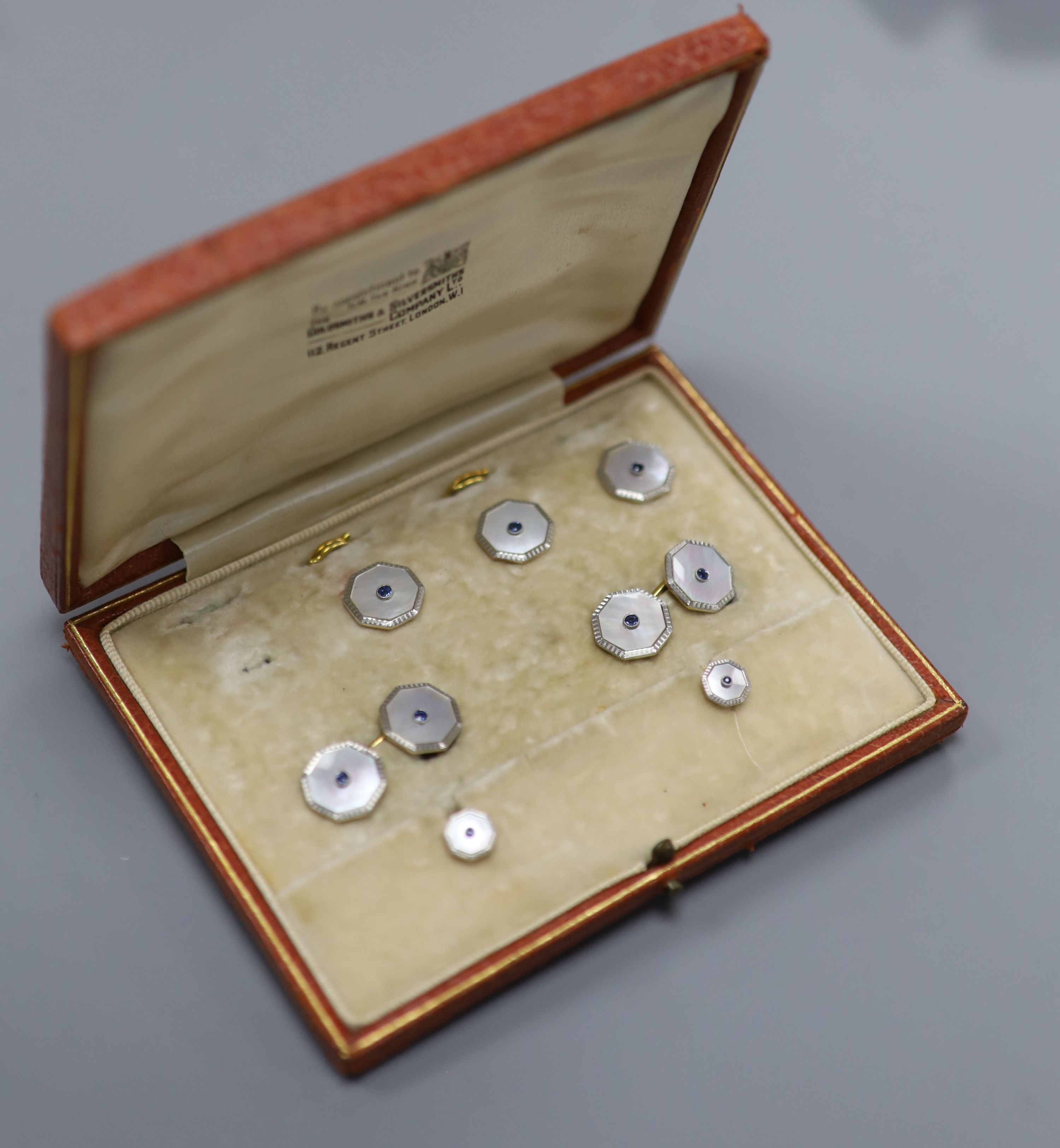An early 20th century 18ct & Pt, mother of pearl and sapphire set octagonal part dress stud set (one stud missing)
